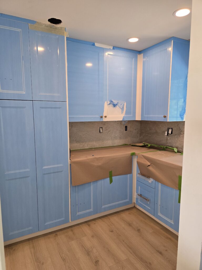 Walk-in pantry with custom cabinets and quartz countertops