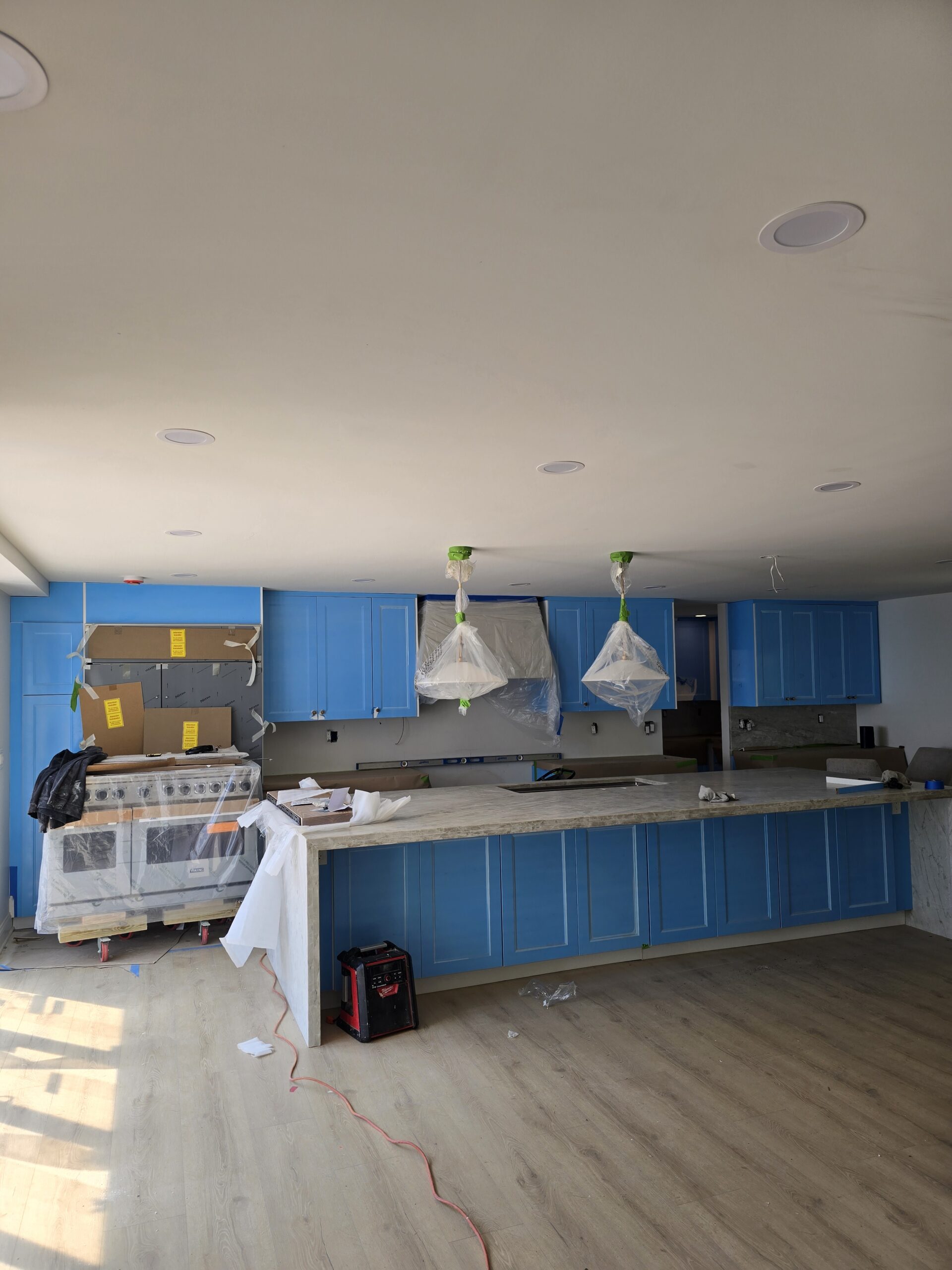 Custom kitchen cabinet installation in progress with large island and premium cabinetry