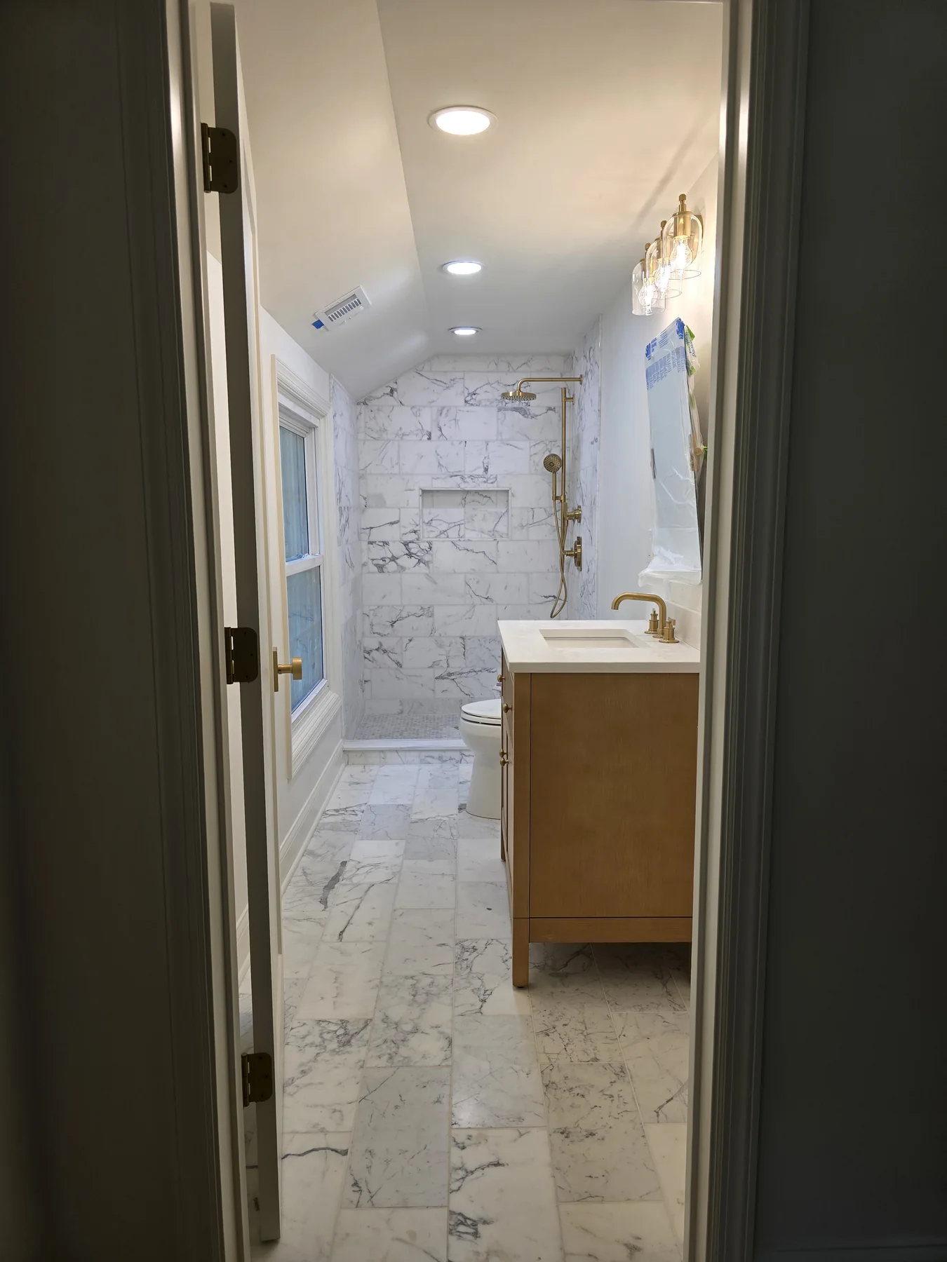 Marble tile bathroom remodel with custom vanity, luxury shower, and premium finishes completed by GetFix4U